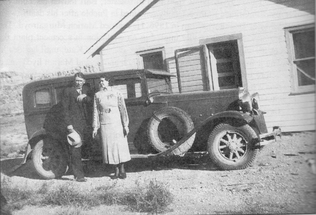 Bart_and_Polly_McBride_in_front_of_their_home_south_of_Sam_and_Kates_home_on_the_McBride_Homestead_1936